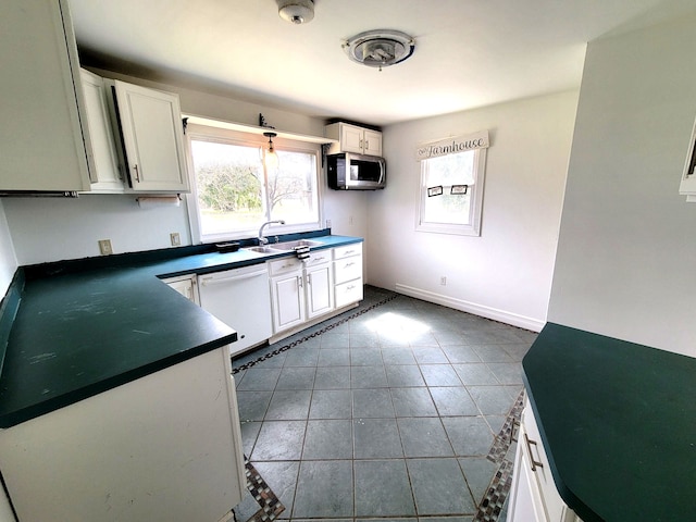 3246 E Maple Ave, Grand Blanc, MI 48507 - kitchen featuring dark countertops, dishwasher, stainless steel microwave, and plenty of natural light