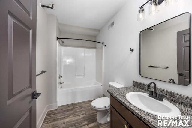 bathroom featuring bathtub / shower combination, visible vents, toilet, vanity, and wood finished floors