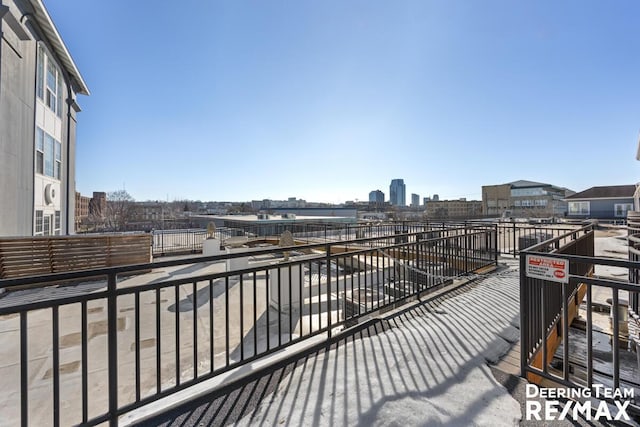 wooden terrace featuring a view of city