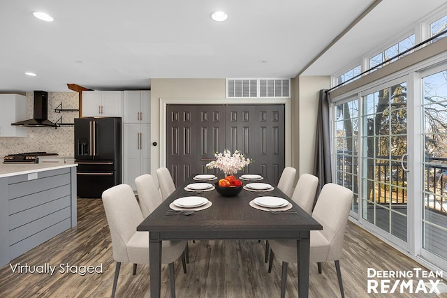 dining space featuring wood finished floors, visible vents, and recessed lighting