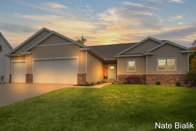 view of front facade with a garage, stone siding, concrete driveway, and a front yard