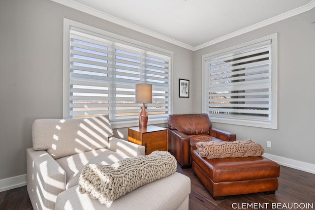 sitting room with baseboards, wood finished floors, and crown molding