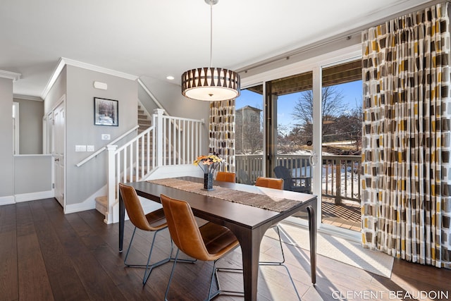 dining area featuring ornamental molding, baseboards, stairway, and hardwood / wood-style floors