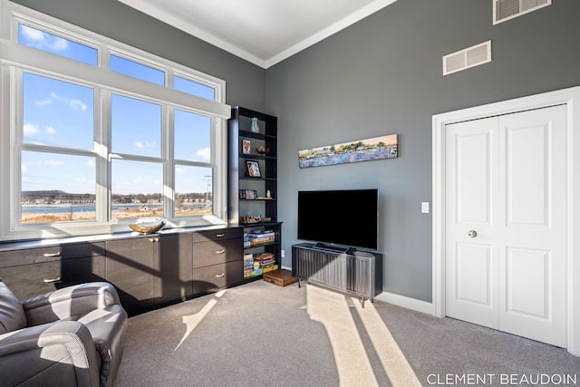 office featuring baseboards, visible vents, crown molding, and light colored carpet