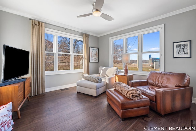 interior space with hardwood / wood-style flooring, visible vents, a ceiling fan, baseboards, and crown molding