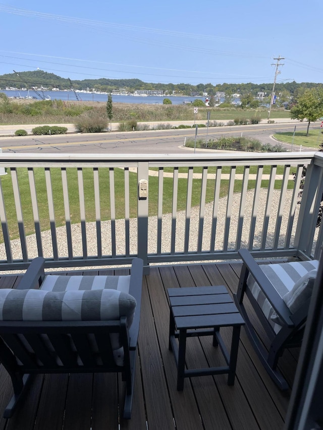 wooden terrace featuring a yard