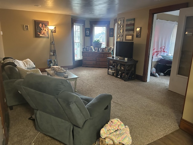 carpeted living area with baseboards