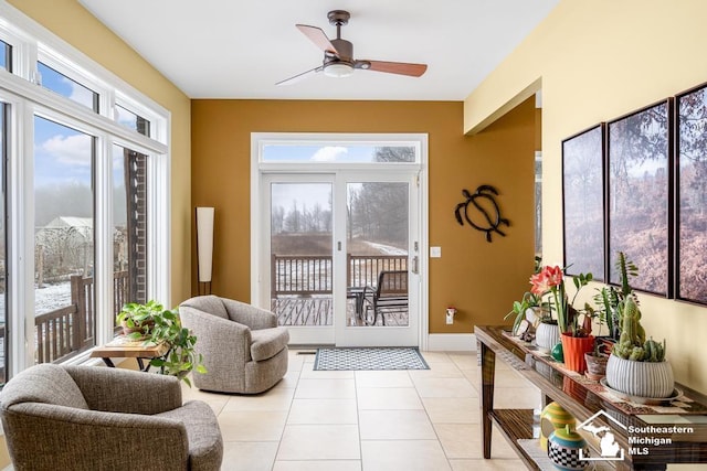 entryway featuring light tile patterned floors, baseboards, a wealth of natural light, and a ceiling fan