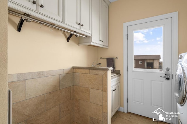 6370 Lewis Ave, Ida, MI 48140 - washroom with washer / clothes dryer, light tile patterned floors, and cabinet space