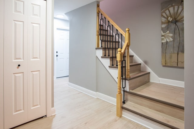 stairway featuring baseboards and wood finished floors