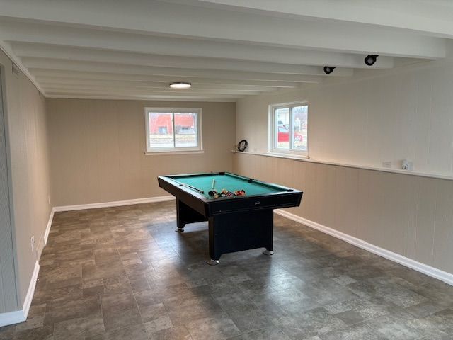 playroom featuring pool table, wood walls, beamed ceiling, and baseboards