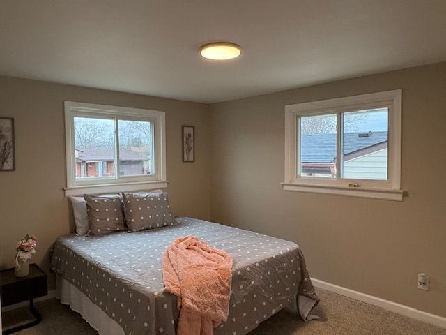 carpeted bedroom featuring baseboards