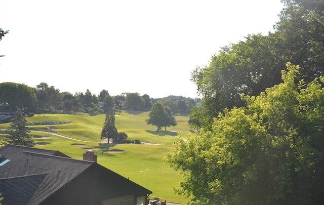 surrounding community featuring a lawn and golf course view