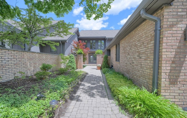 view of exterior entry with brick siding