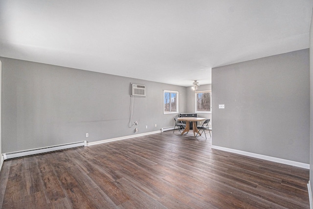 unfurnished living room featuring a wall mounted AC, a baseboard radiator, wood finished floors, and baseboards