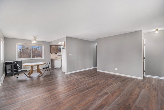 interior space with dark wood-style flooring and baseboards