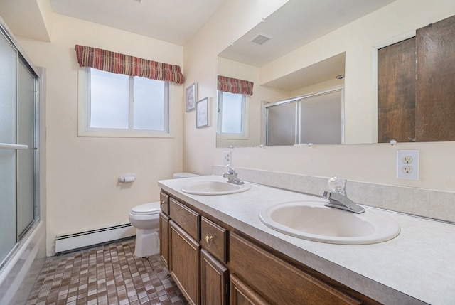 bathroom featuring toilet, a baseboard radiator, a sink, and visible vents