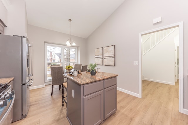 kitchen with decorative light fixtures, light wood-type flooring, gray cabinets, an inviting chandelier, and stainless steel appliances