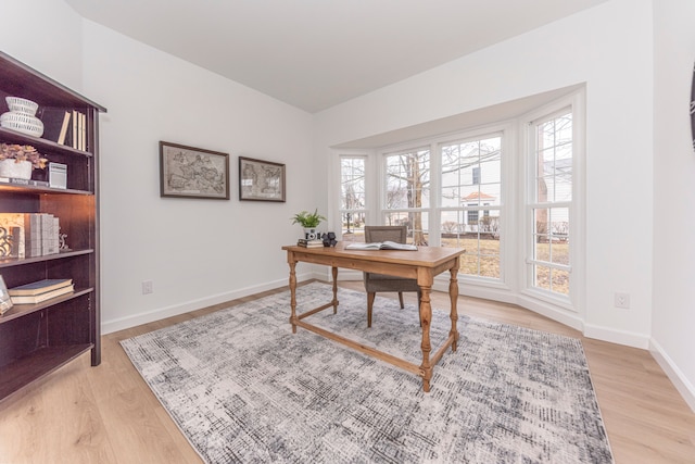 home office featuring baseboards and light wood-type flooring