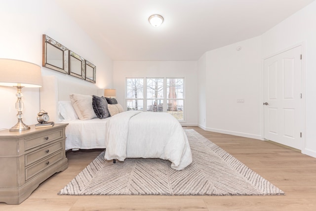 bedroom with light wood-style floors and baseboards