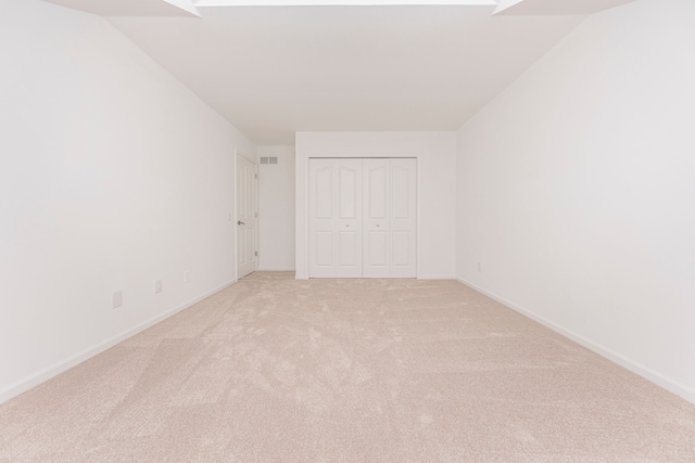 empty room with light colored carpet and baseboards