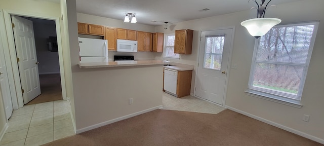 kitchen with light colored carpet, white appliances, light countertops, and light tile patterned floors