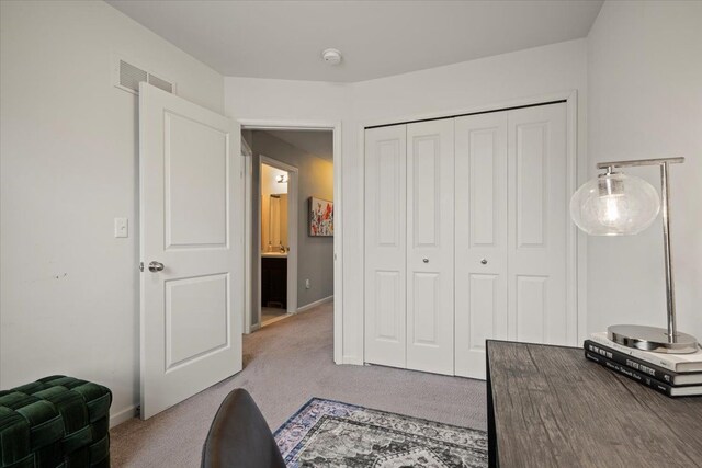 office area featuring carpet flooring, visible vents, and baseboards