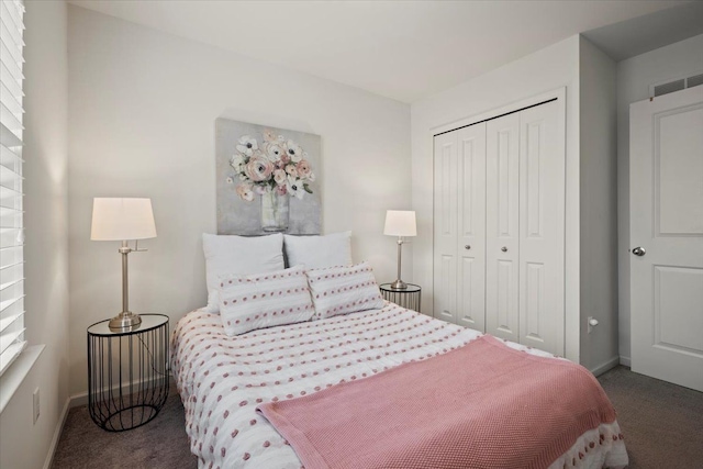 bedroom featuring a closet, carpet flooring, visible vents, and baseboards