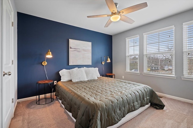 carpeted bedroom featuring ceiling fan and baseboards