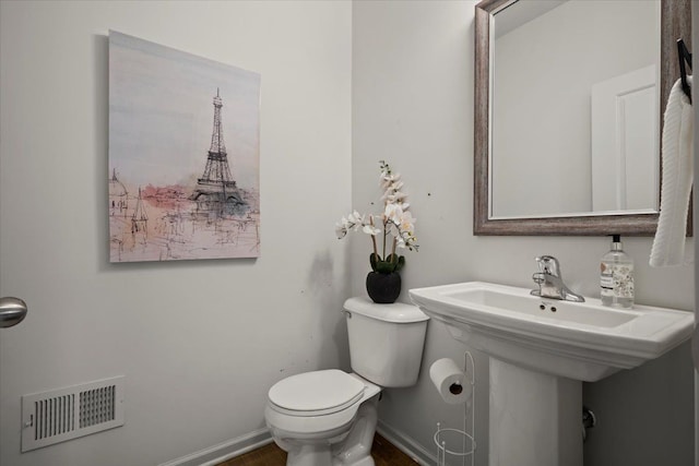 bathroom with baseboards, visible vents, and toilet