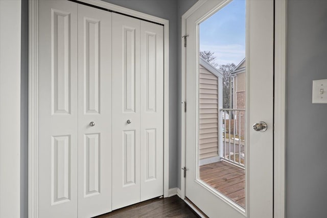 doorway to outside with dark wood-style flooring and baseboards