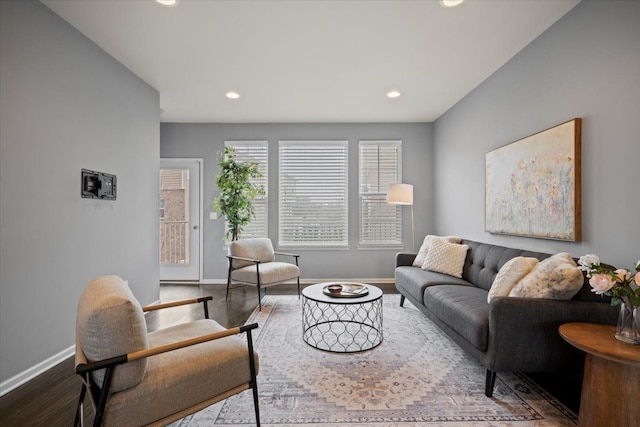 living area featuring baseboards, wood finished floors, and recessed lighting