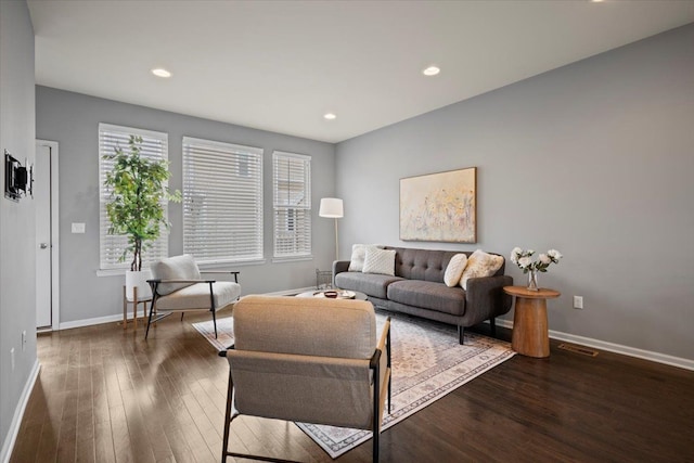 living room with recessed lighting, wood-type flooring, visible vents, and baseboards