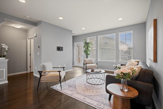 living room featuring baseboards, wood finished floors, and recessed lighting