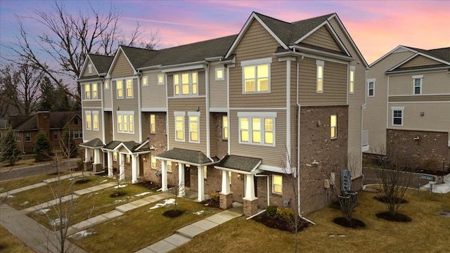 townhome / multi-family property with brick siding