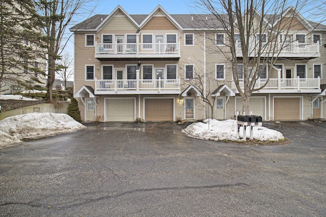 view of property with a garage and driveway