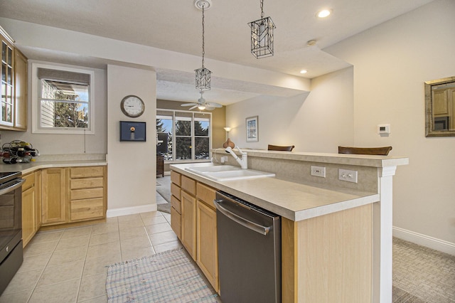 kitchen featuring decorative light fixtures, light countertops, appliances with stainless steel finishes, a sink, and an island with sink