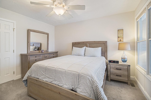 carpeted bedroom featuring visible vents, ceiling fan, and baseboards