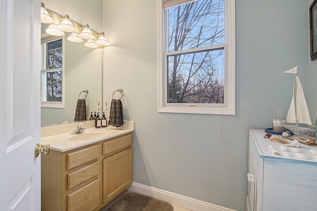 bathroom featuring baseboards and vanity