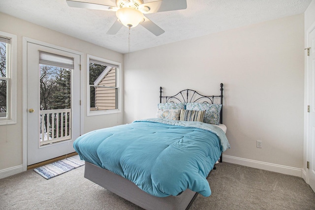 carpeted bedroom featuring a textured ceiling, access to outside, and baseboards