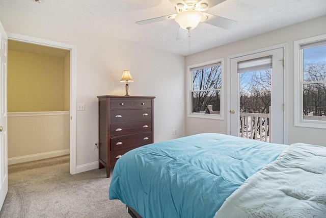 bedroom featuring access to exterior, multiple windows, baseboards, and light colored carpet