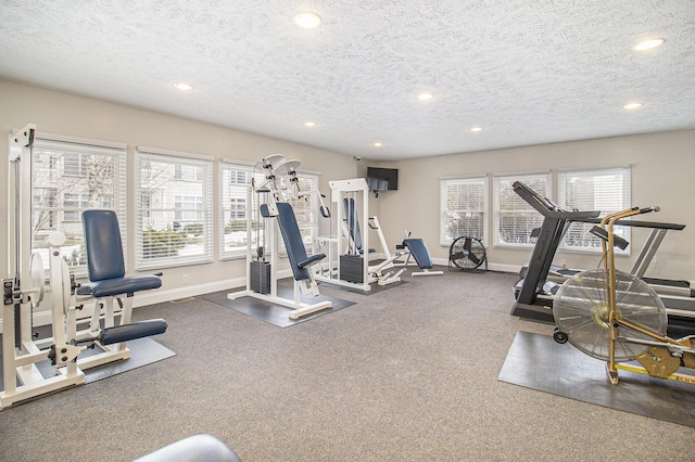 gym featuring recessed lighting, a textured ceiling, and baseboards