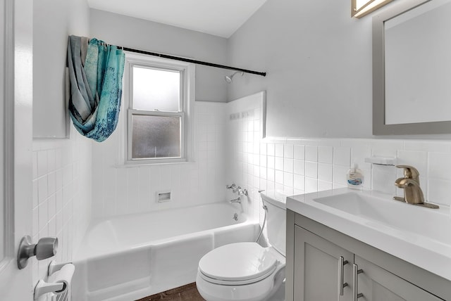 bathroom with toilet, shower / bath combination, tile walls, and vanity