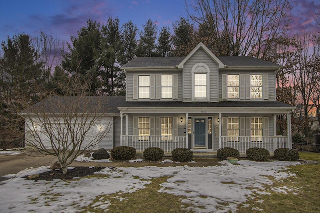 view of front of home featuring a garage and a porch