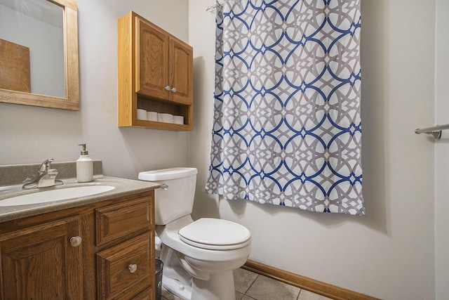 bathroom with vanity, toilet, and tile patterned floors