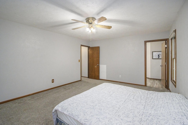 bedroom featuring baseboards, a ceiling fan, and light colored carpet