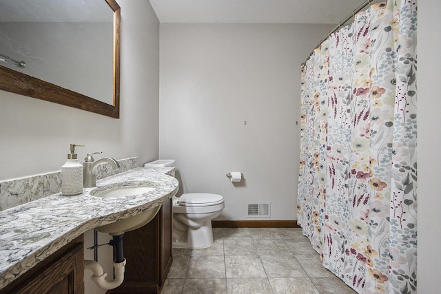 bathroom with tile patterned flooring, toilet, a sink, visible vents, and baseboards