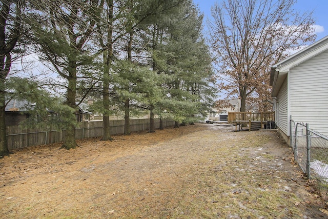 view of yard featuring fence and a wooden deck