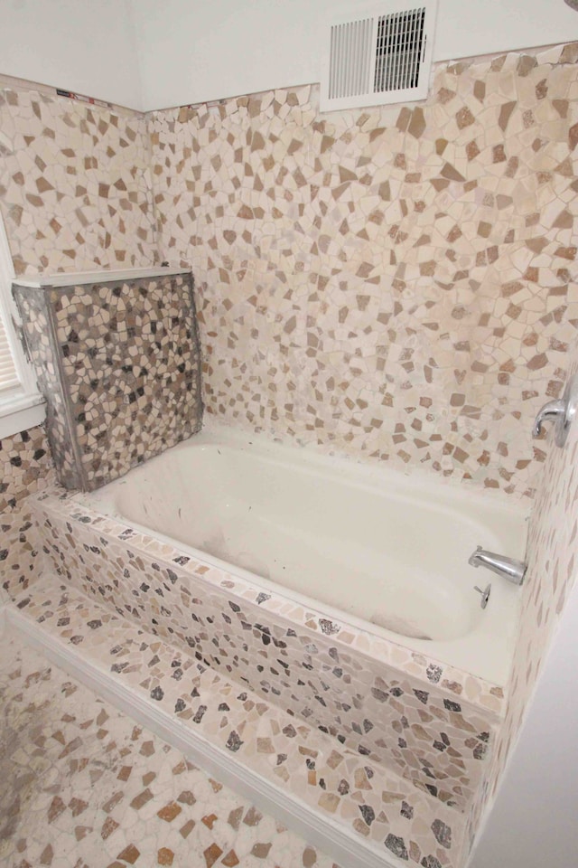 full bath with a tub and visible vents