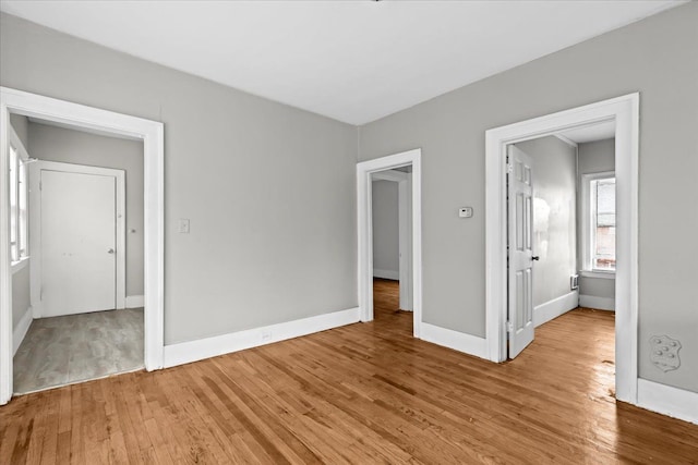 unfurnished bedroom featuring light wood-type flooring and baseboards